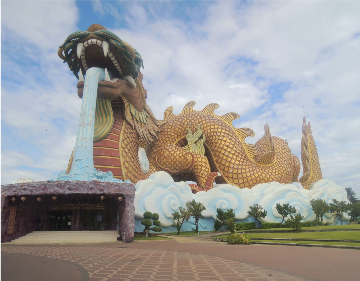 A grand dragon statue sits outside a temple in Suphan Buri Thailand the City of Gold