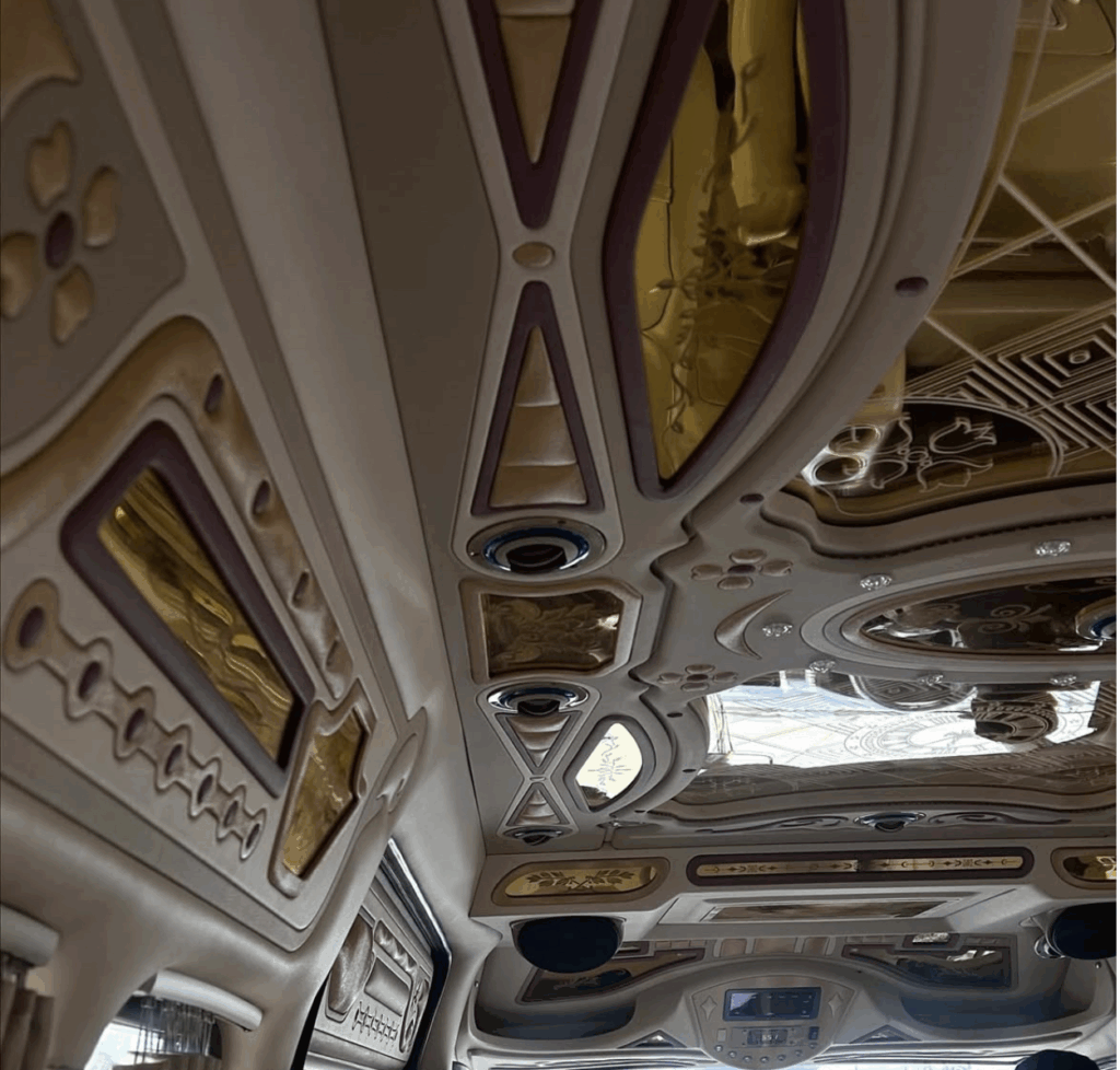 the inside of a Thai sprinter van coloured in beige and gold