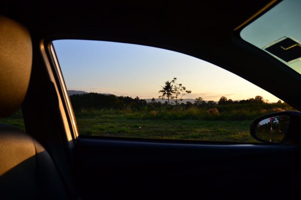 a view of the sunset from inside a car