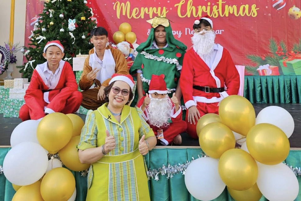 A group of teachers in Thailand pose together in Christmas costumes